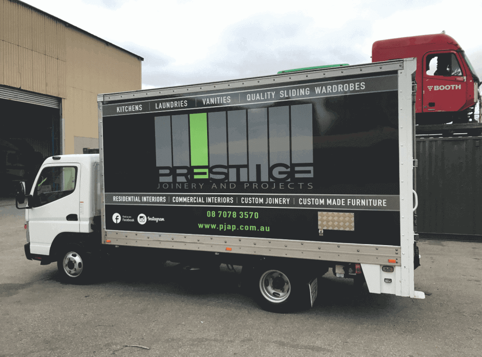 A delivery tuck that has a vehicle wrap style large format sign which is a reproduction of the company's website
