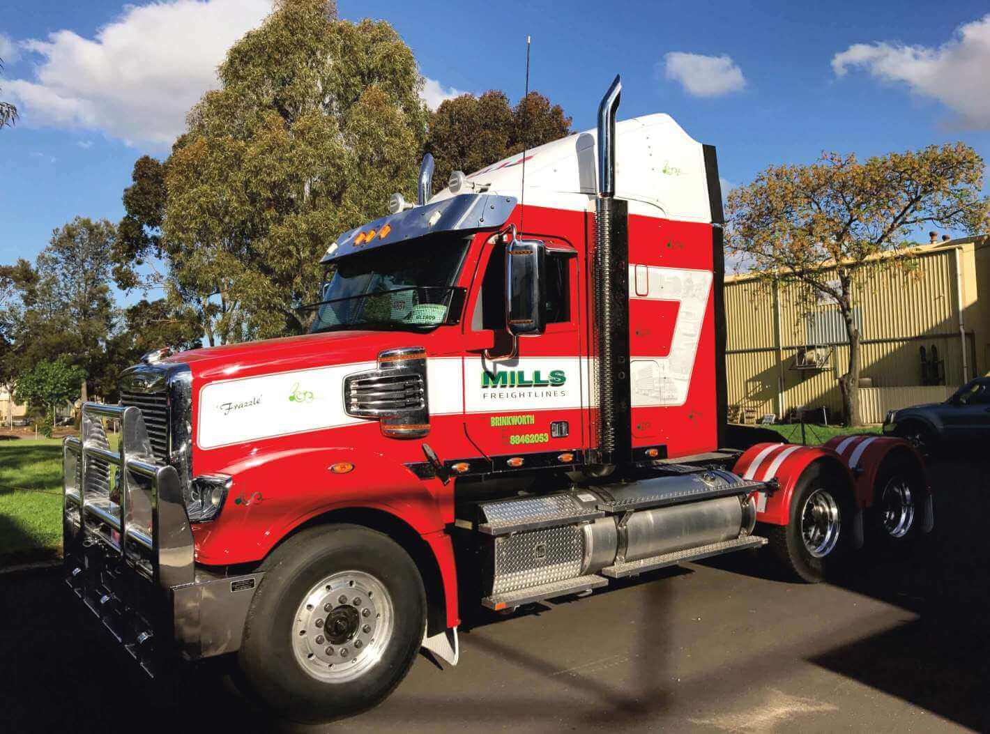 A semi trailer cabin that features a variety of different sign writing styles and decals