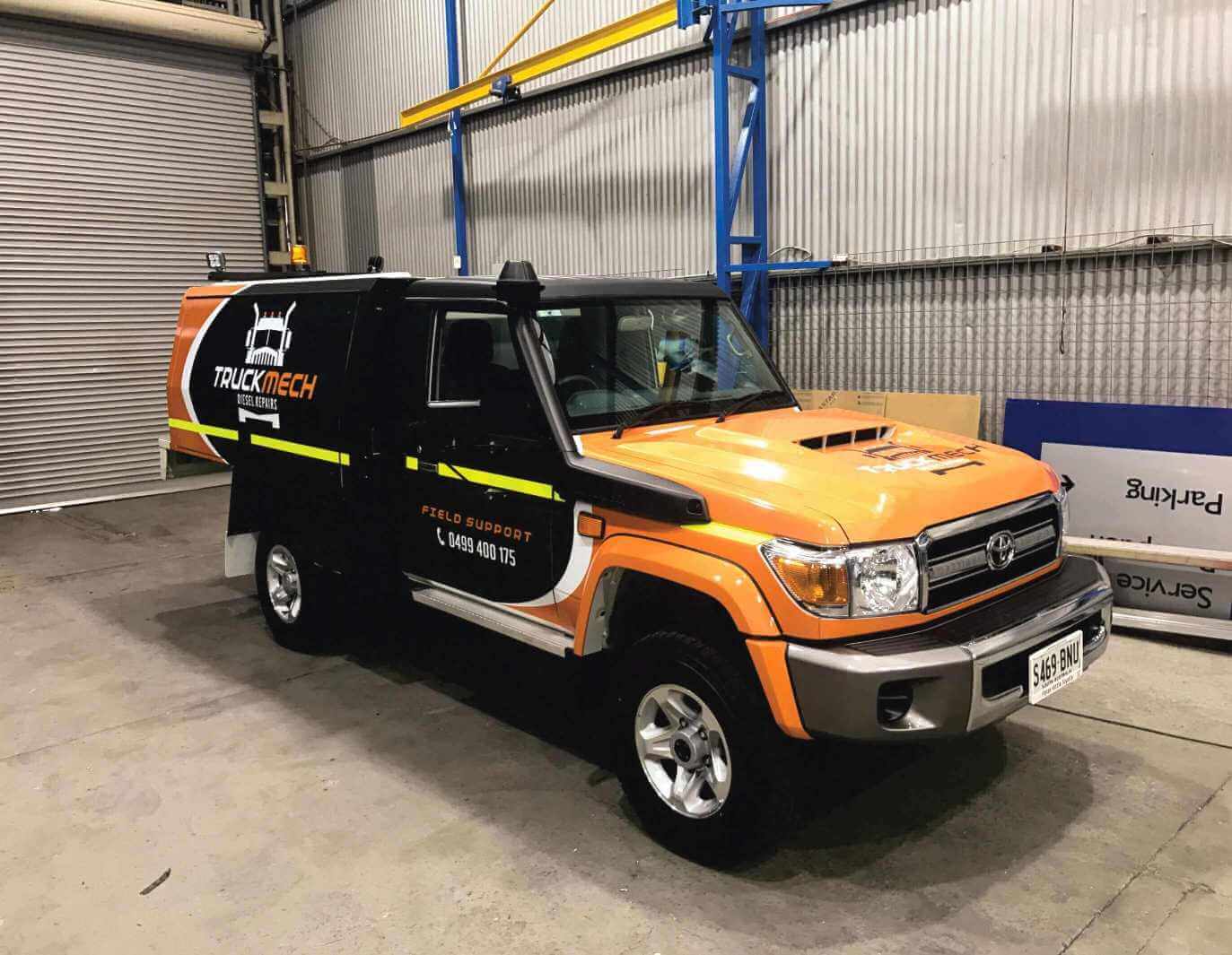 Vehicle decals and lettering - A field service support vehicle which has been spray painted in three different colours and has had vehicle decals and lettering applied